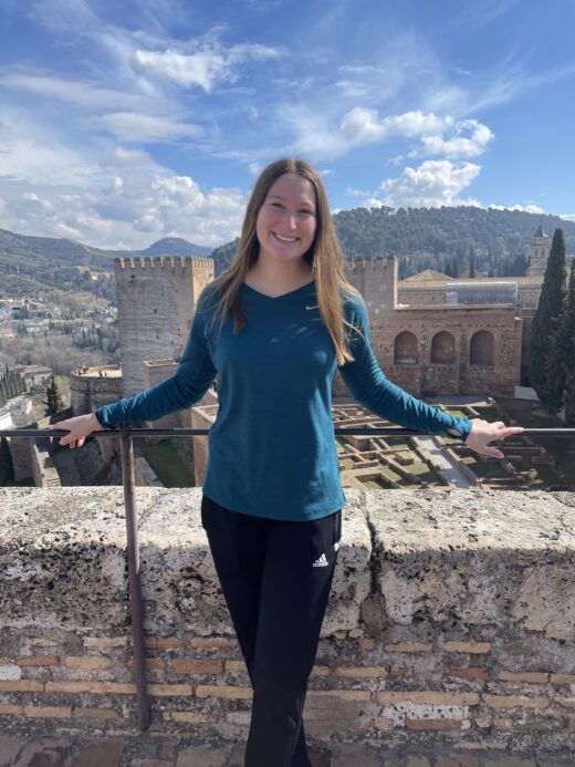 Girl posing on ledge.