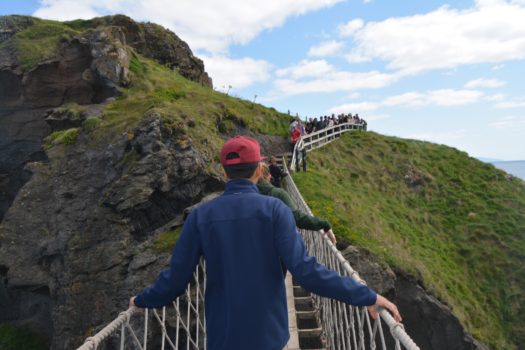 Students walking on a rope bridge.